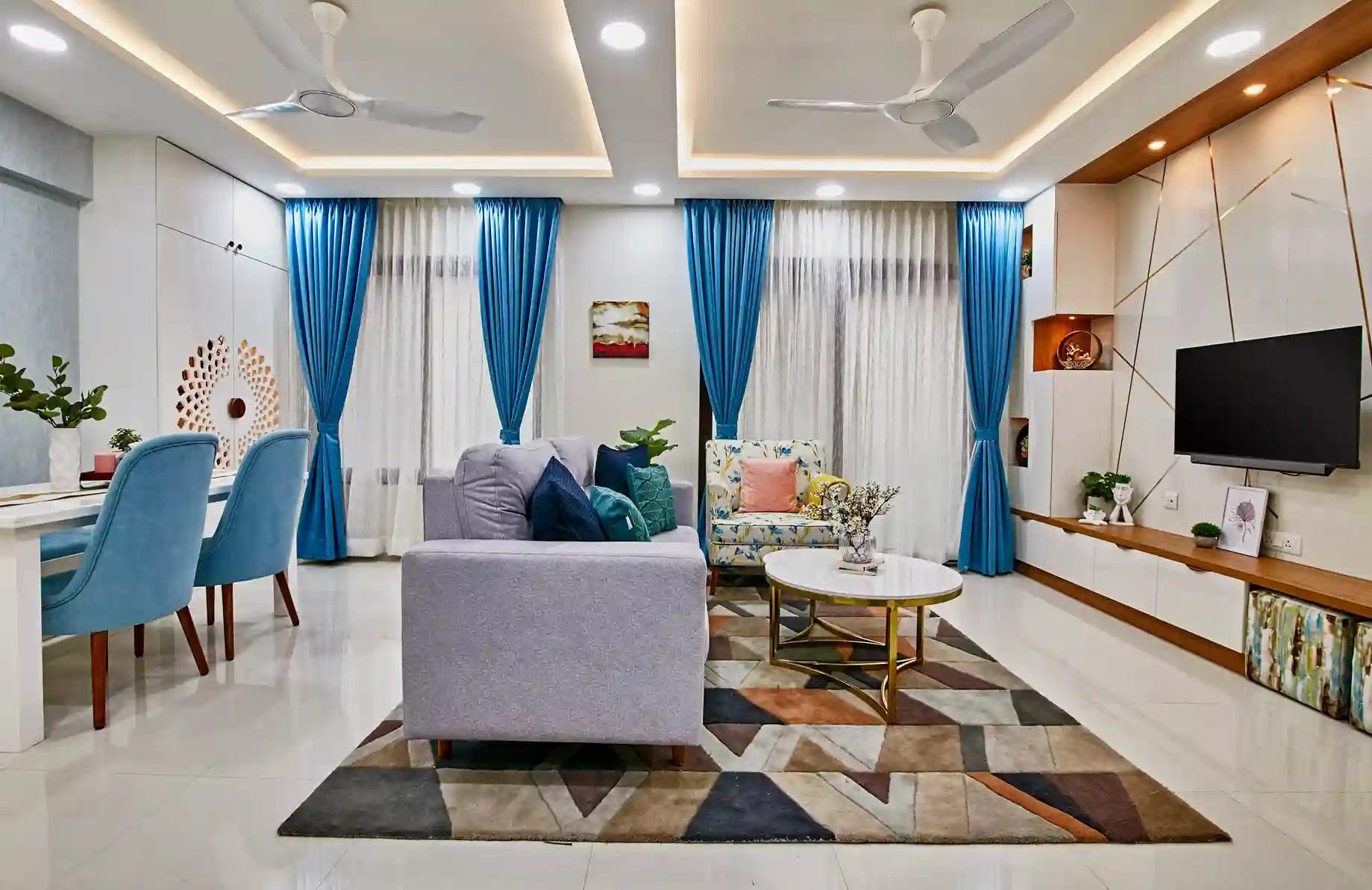 A modern living room Interior Design with a big TV unit in Bangalore by Interiosplash Interior Design Company